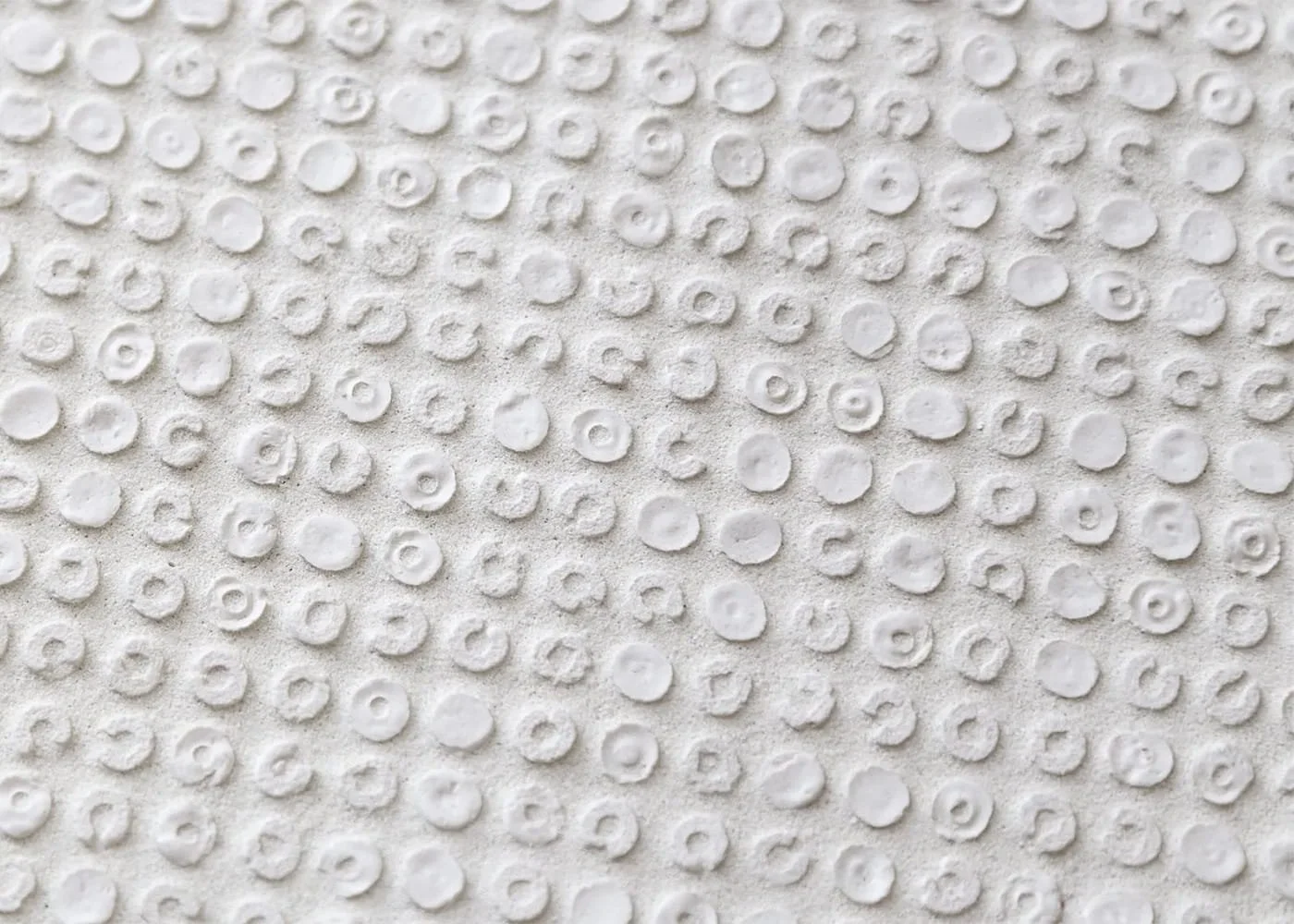 White recycled glass mosaic tile circular textured pattern architectural surface detail