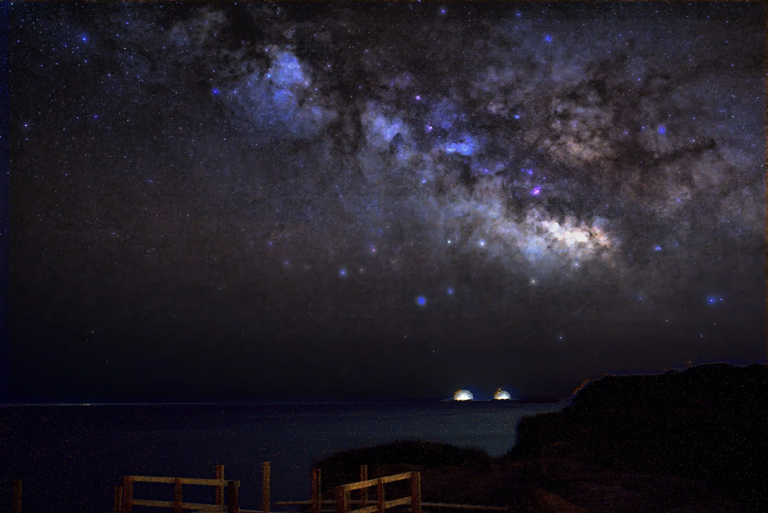 Vigil at the Salt Gate: the Milky Way over a wooden railing on a coastal bluff, with two harbor lights on the dark water