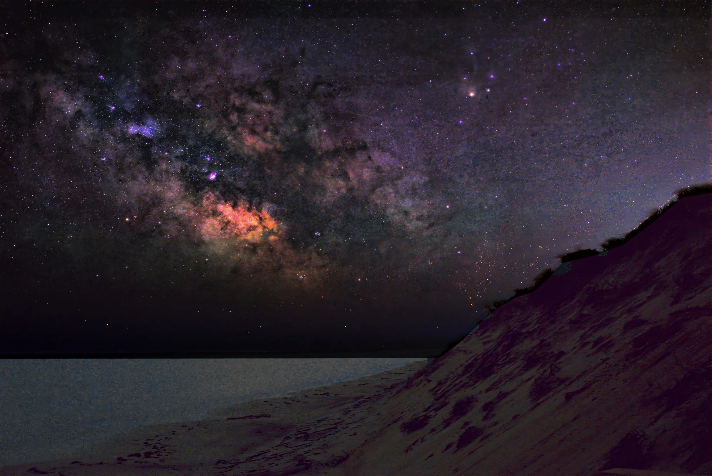 Bluff Light: the Milky Way rising over a sand bluff above the beach at night