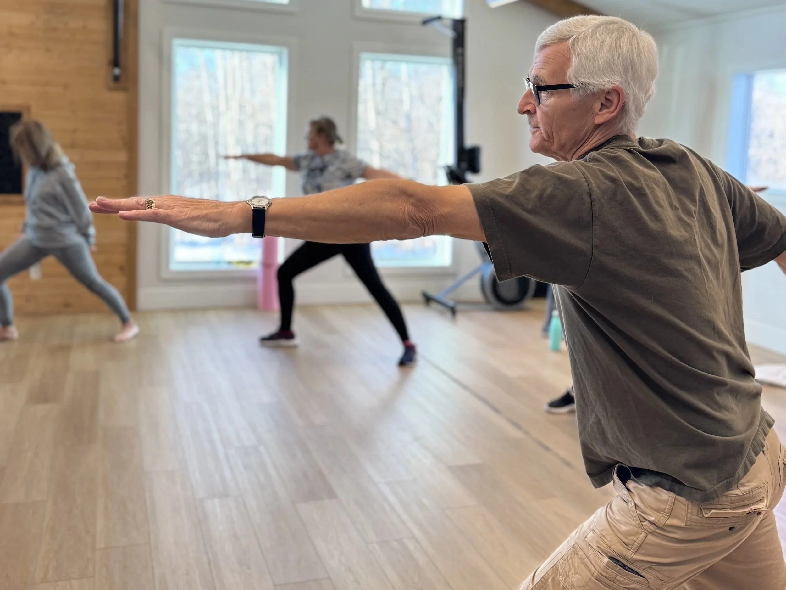 senior men and women stretching in an exercise class