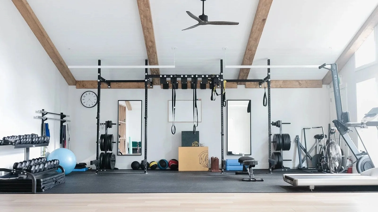 brightly lit gym space showing exercise equipment