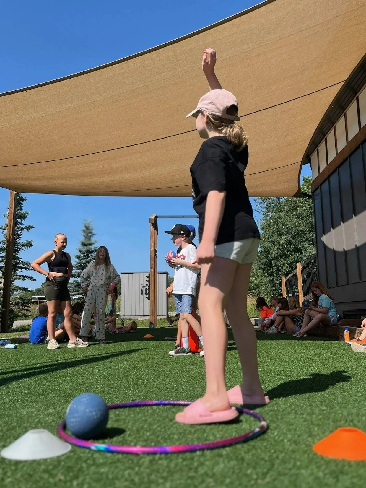 Camp Move Your Mood campers building teamwork skills through movement activities at Restorative Whole Health's summer camp in Okotoks