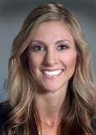 A young woman with blonde hair and a bright smile.