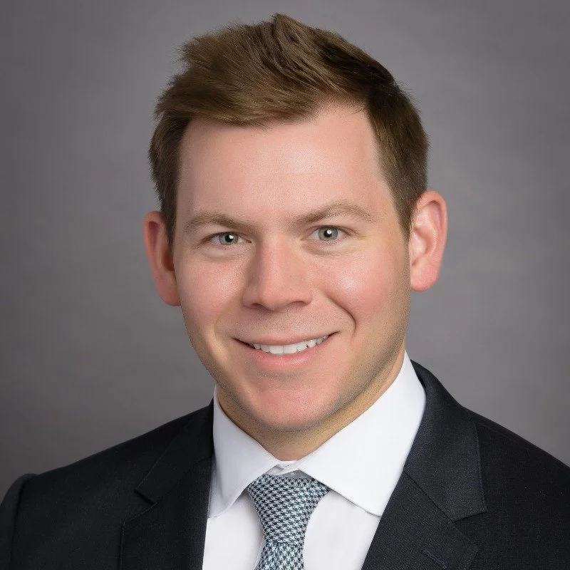 Silhouette of a person's head and shoulders against a gray background