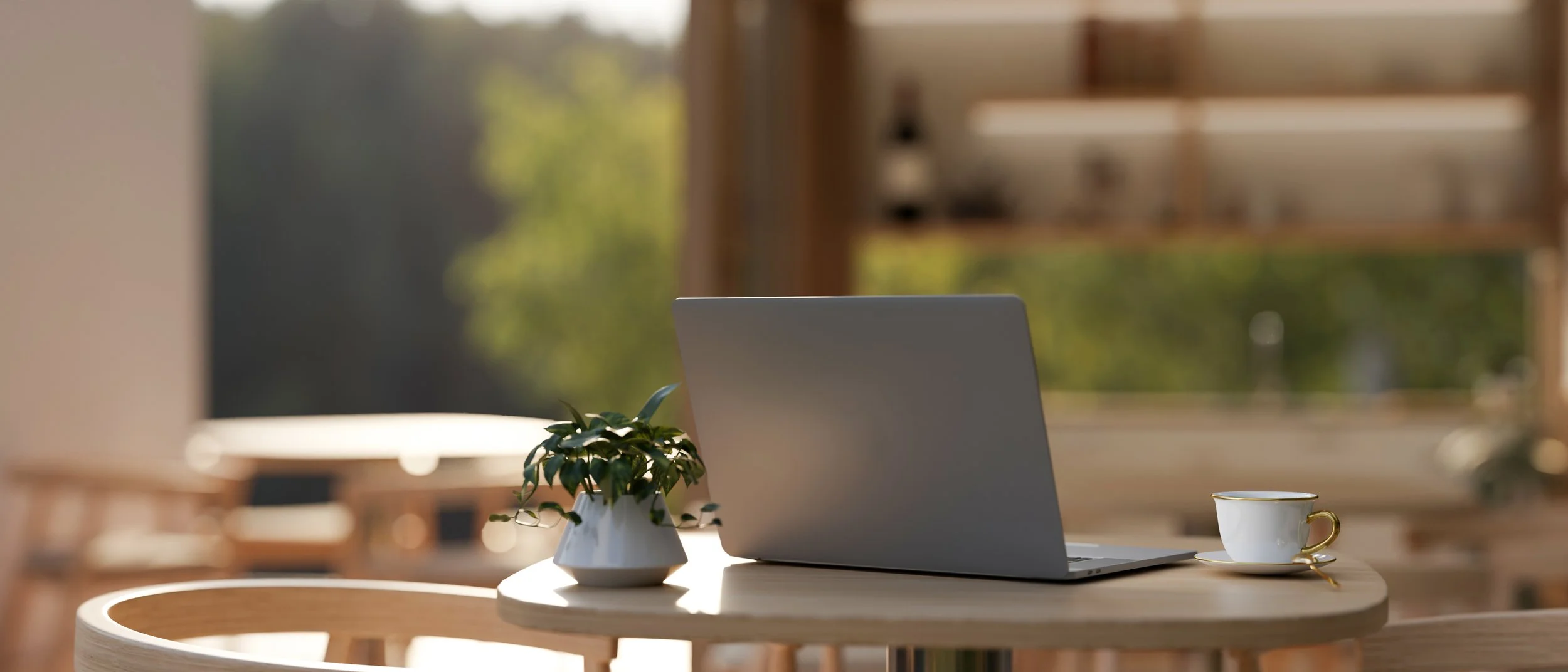 Soft morning light through a window, laptop, cup, and plant representing gentle recovery from depression through online therapy in the UK.