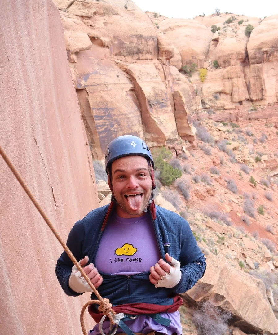 "I like rocks" purple t-shirt worn while climbing the red rocks outside of Moab, UT.
