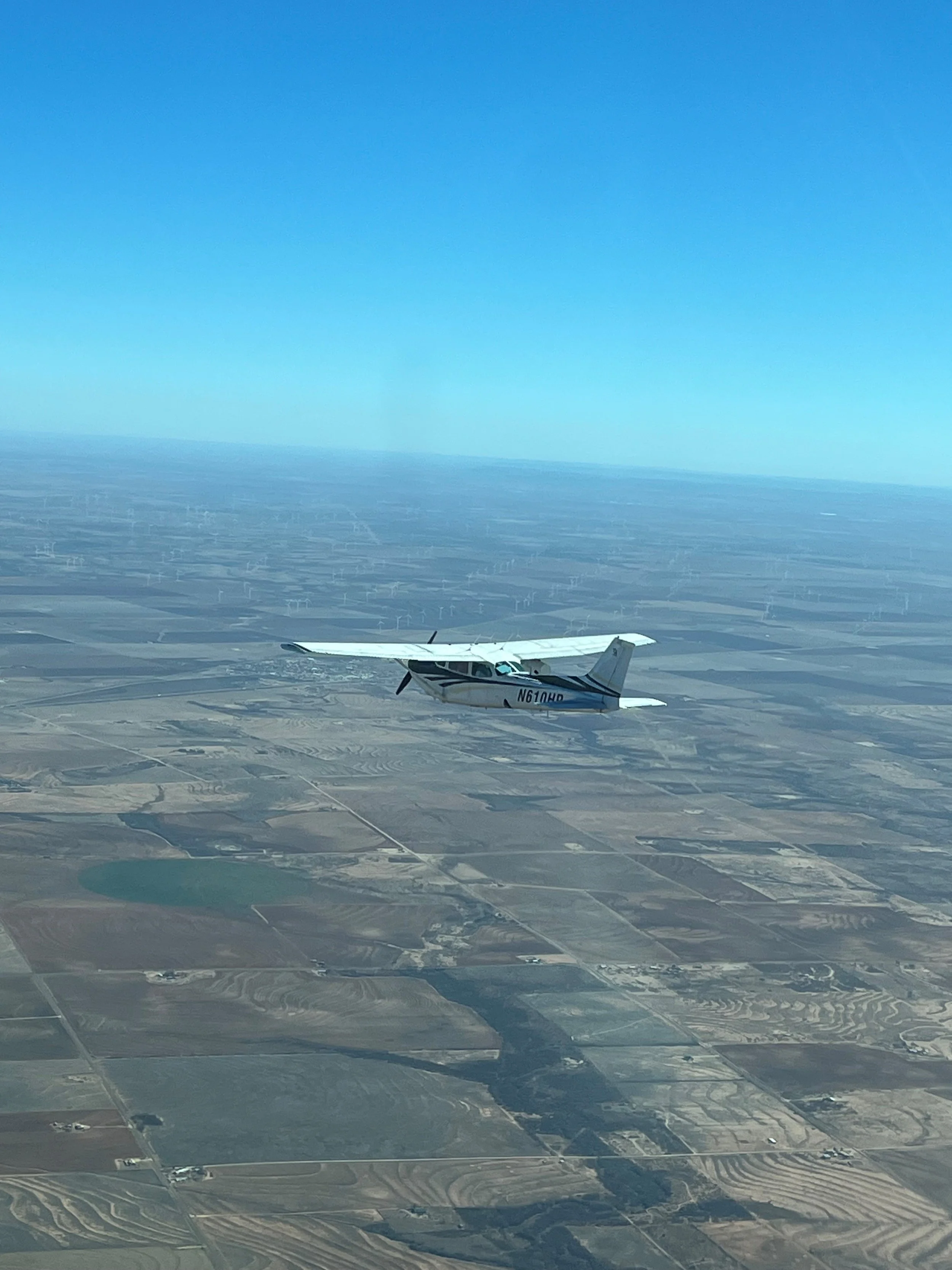 aerial view of an airplane monitoring pipeline and infrastructure for oil and gas environmental compliance