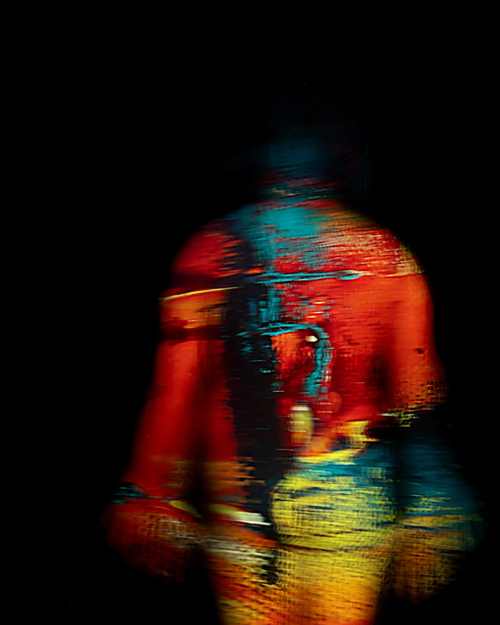 Distorted and colorful image of a person with a dark background.