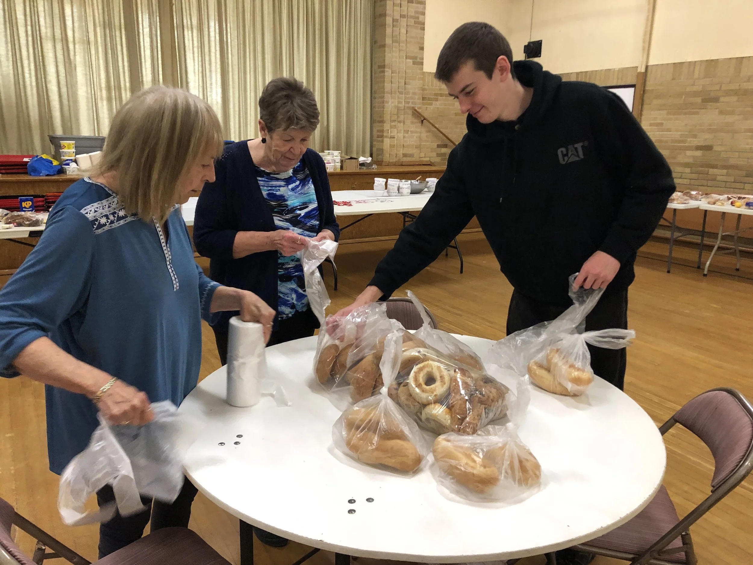Gift of Grace Soup Kitchen bagging bread June 2025.jpg