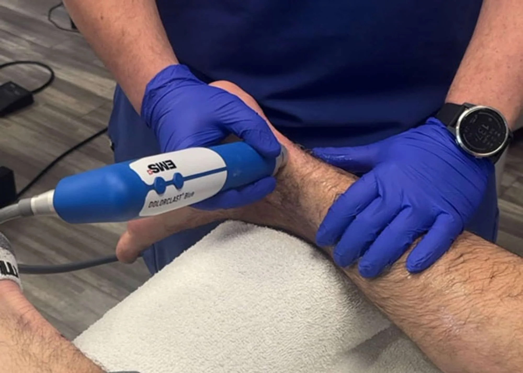 Why tendon pain becomes "stubborn" and why rest alone fails. Achilles tendinopathy being treated with shockwave therapy. Why Tendon Pain Becomes Stubborn
