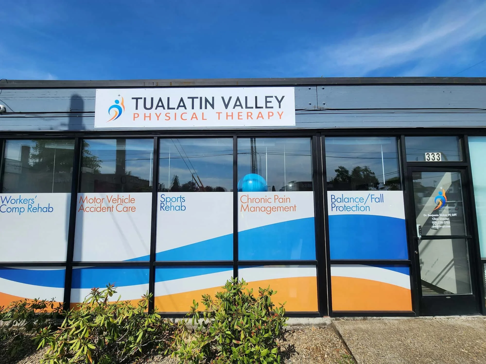 An image of the outside storefront of Tualatin Valley Physical Therapy with vinyl window covers advertising what TVPT treats