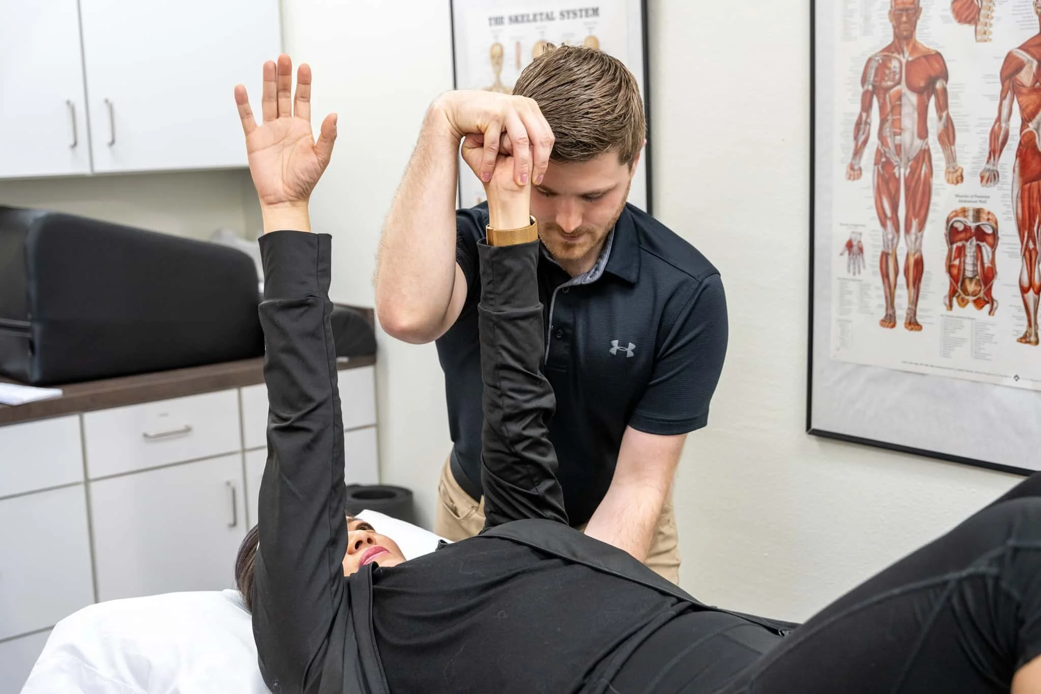 A physical therapist assessing a patient's shoulder strength for an evaluation for a possible rotator cuff injury. Rotator cuff pain treatment in Hillsboro, OR