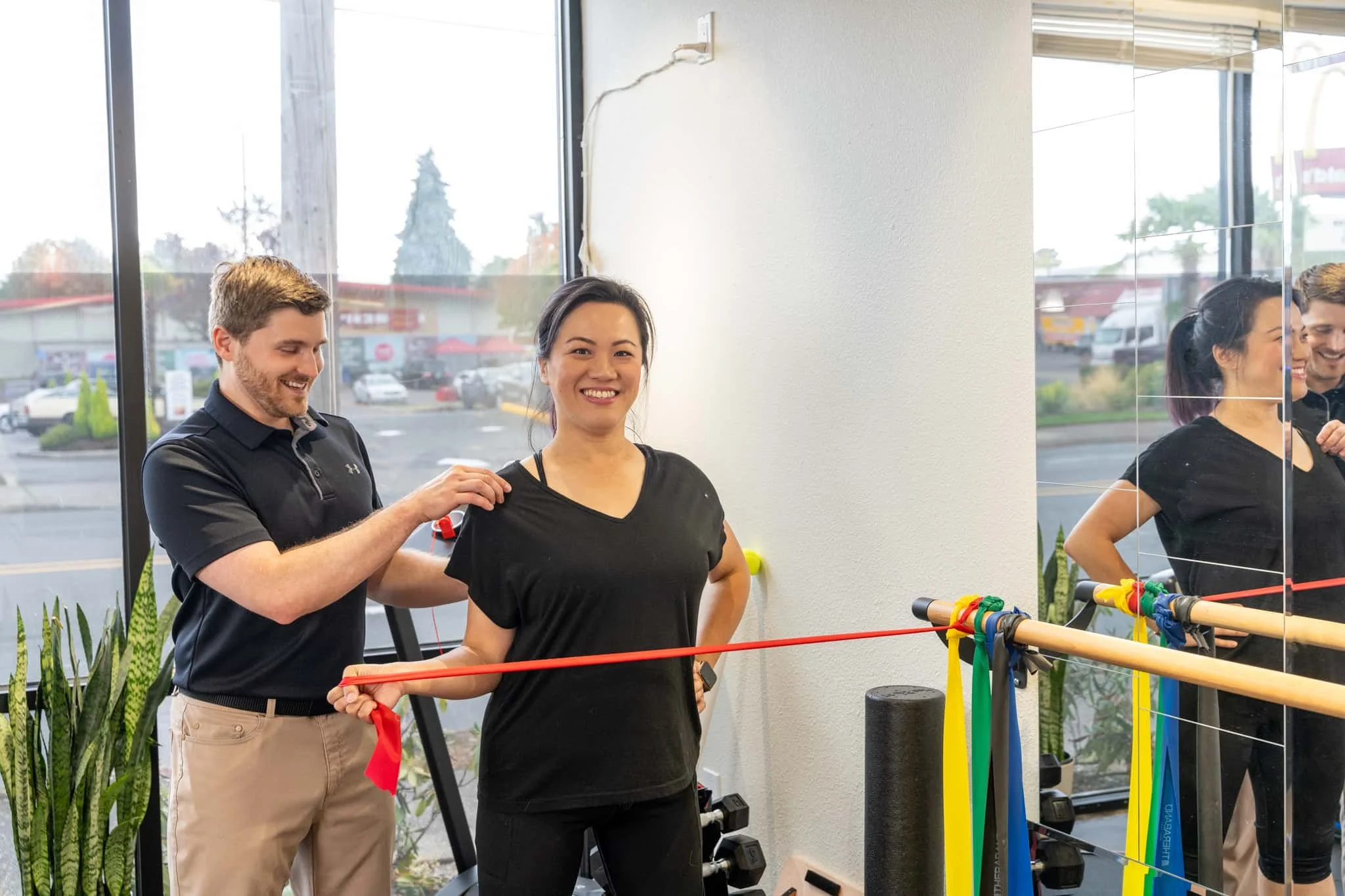 A physical therapist assessing a patient's shoulder during treatment for shoulder impingement