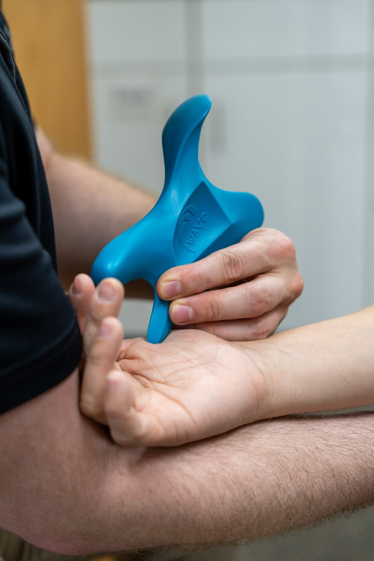 Physical therapist treating trigger finger pain in Hillsboro, Oregon