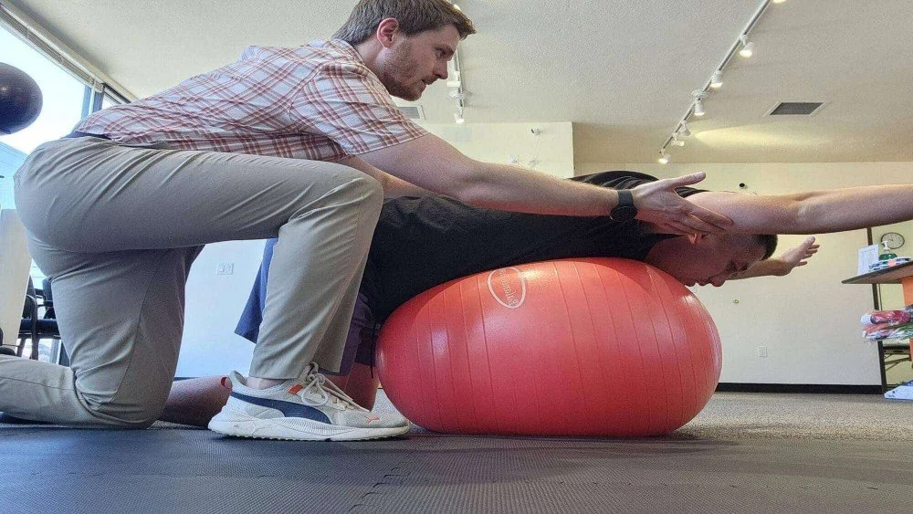 Physical therapist helping patient recover from frozen shoulder in Hillsboro, Oregon