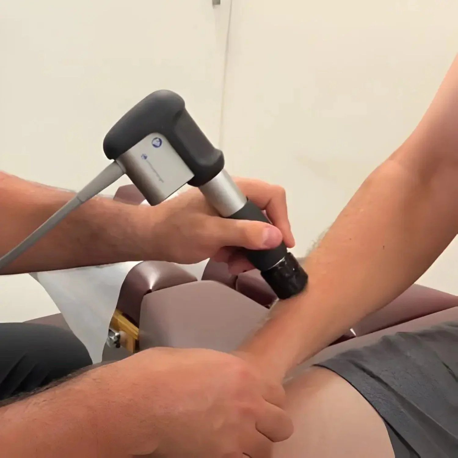 A photo of a patient receiving shockwave therapy for wrist and hand pain treatment in Hillsboro, OR