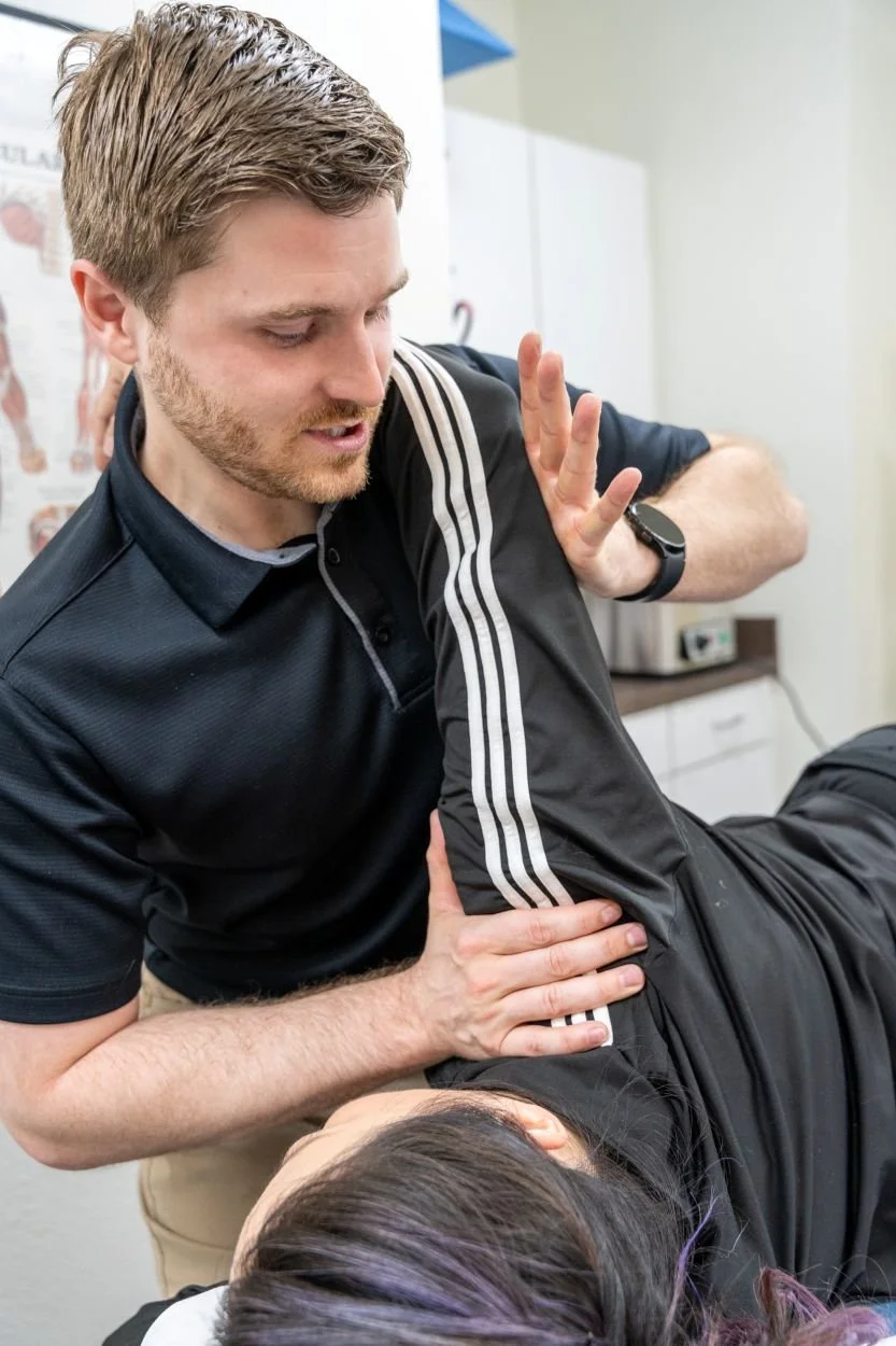A photo of a physical therapist assessing a patient's shoulder mobility for treating frozen shoulder in Hillsboeo Oregon