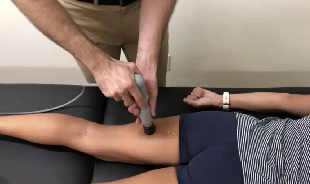 A photo of a patient receiving shockwave therapy for proximal hamstring tendinopathy treatment in Hillsboro, OR
