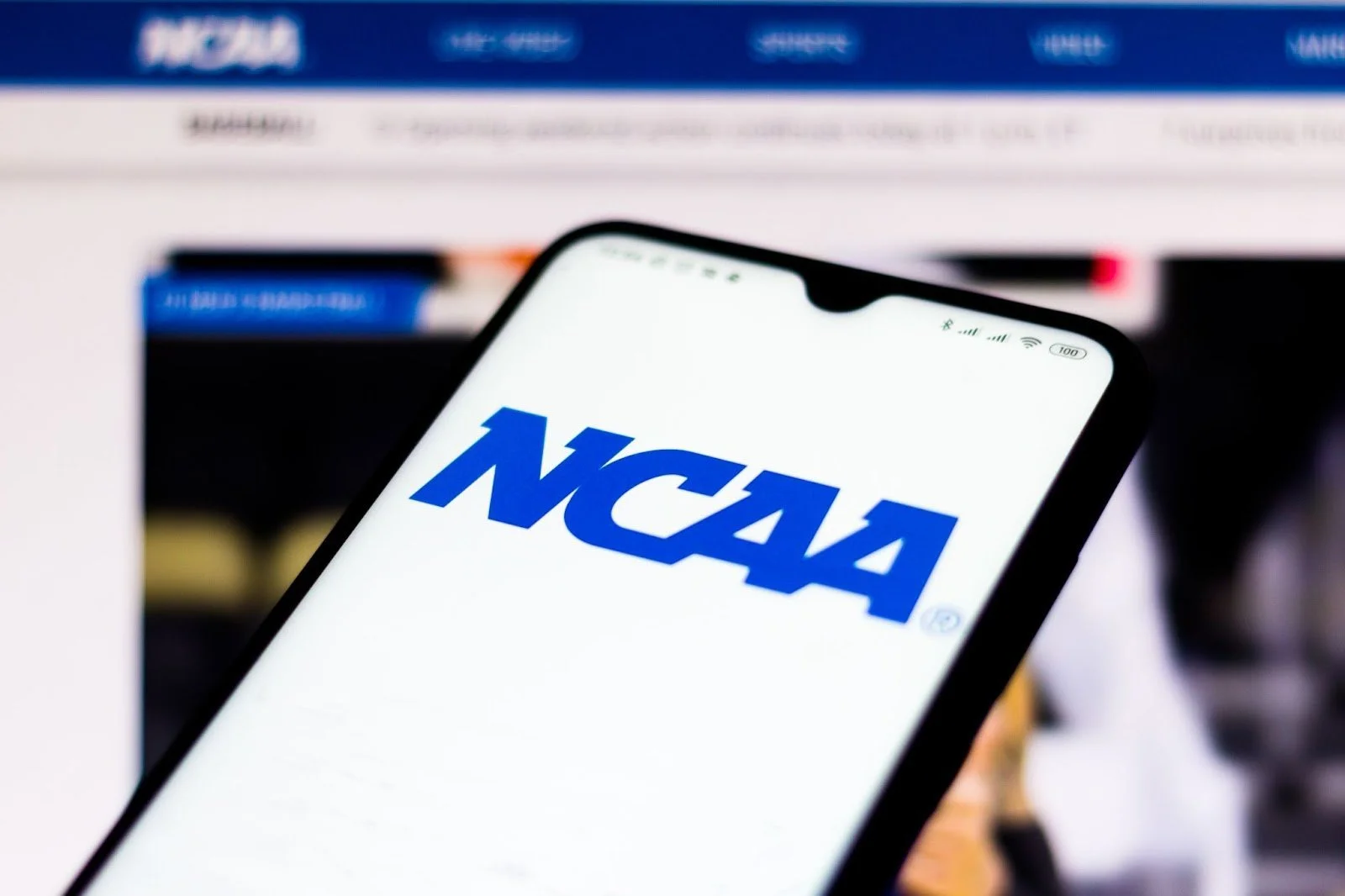 A smartphone displaying the NCAA logo on its screen.
