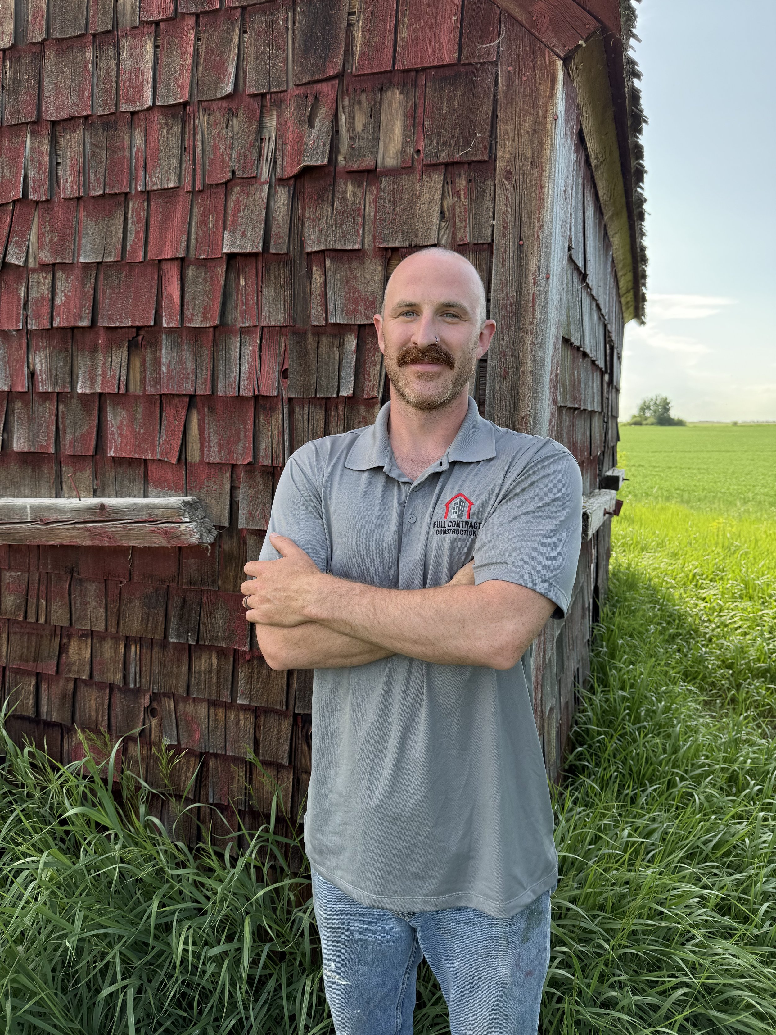 Black and white illustration of a man wearing a hard hat with a beard, seen in profile.