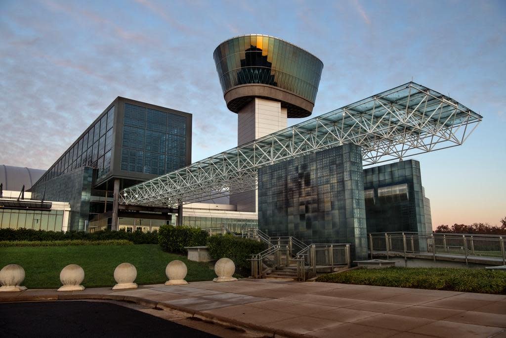 Modern building with glass and metal structure, observation tower, and walkway