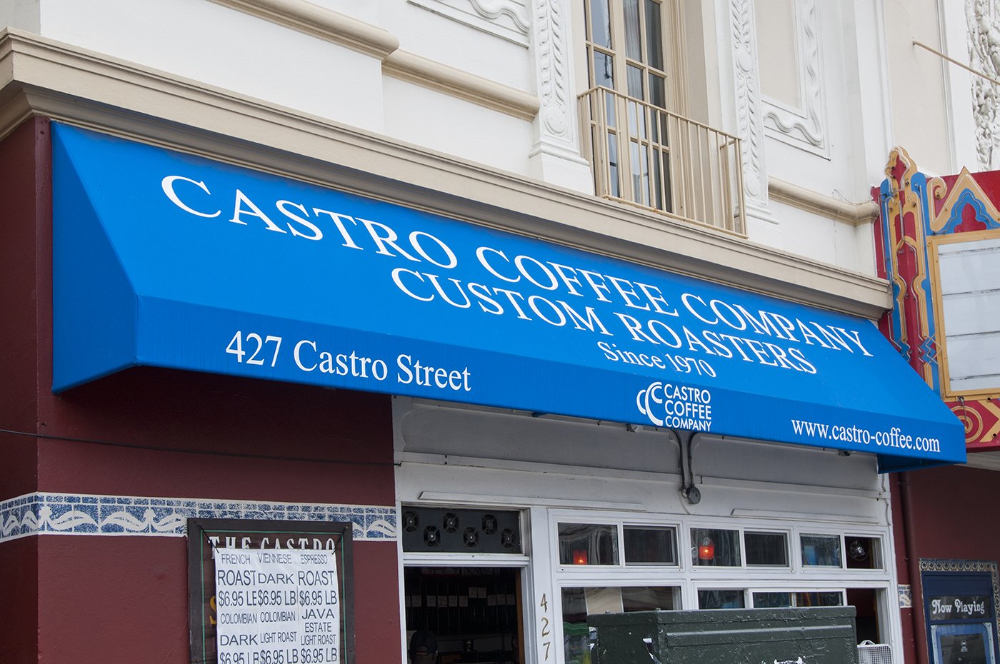 Blue awning of Castro Coffee Company with address 427 Castro Street.