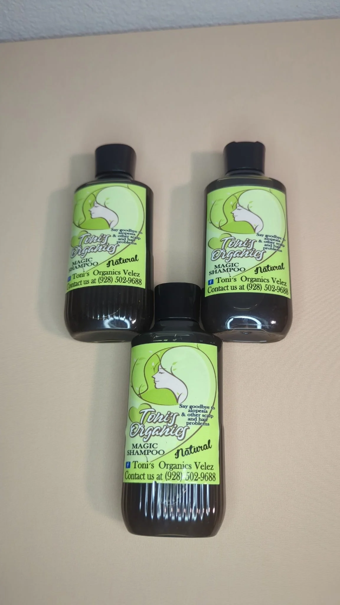 Three bottles of Tony's Organics Velez natural magic shampoo arranged on a light-colored surface.