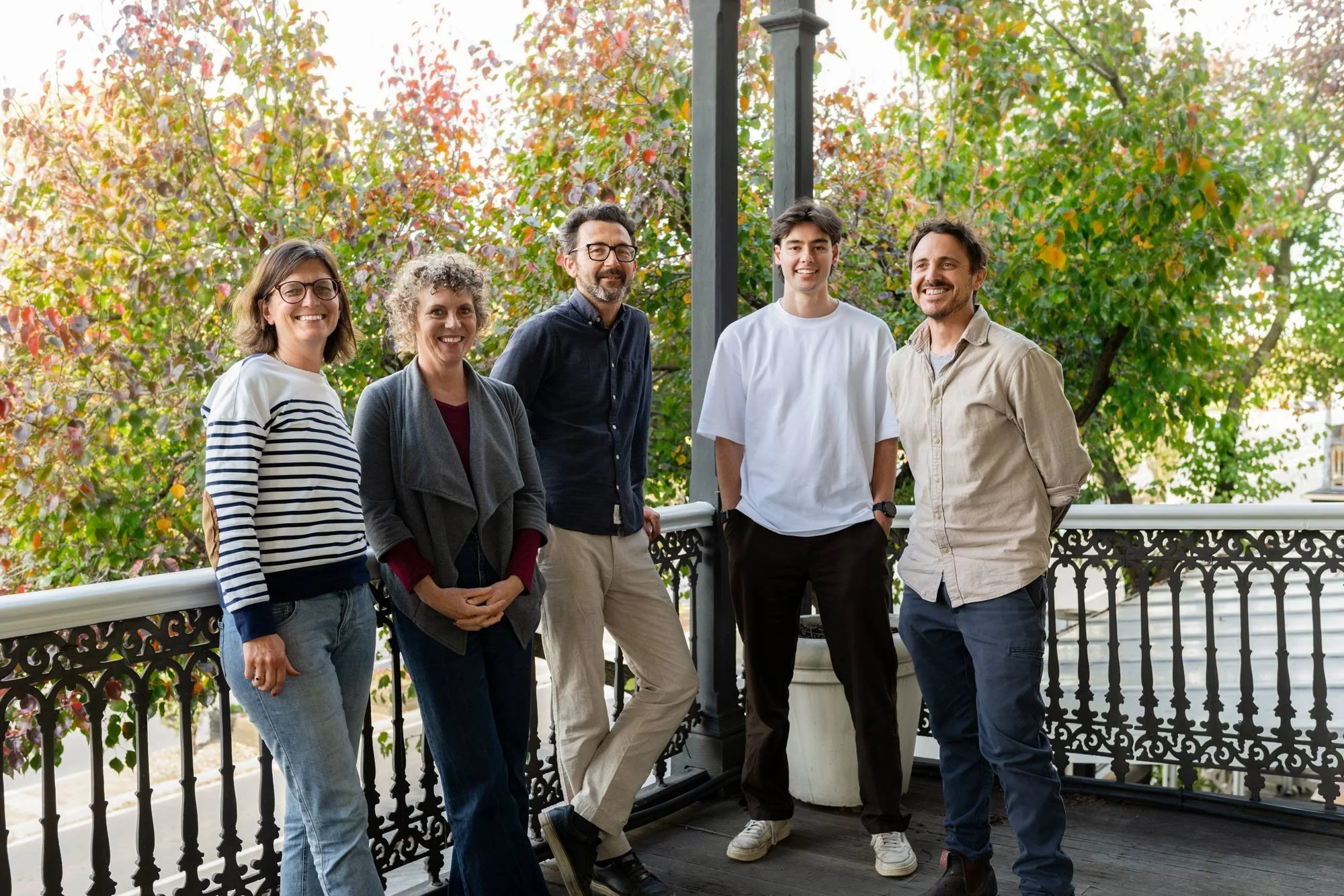 Khab's staff members standing on an Edwardian balcony with autumn foliage in the background.