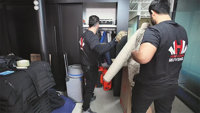 Elderly couple sitting together and relaxing during their moving day, surrounded by cardboard boxes—capturing a calm and stress-free relocation experience for seniors.