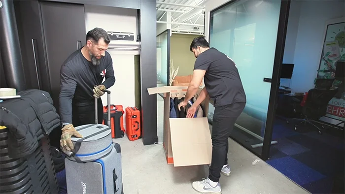 Professional movers handling boxes and office equipment during a commercial office move in Toronto with organized relocation services.