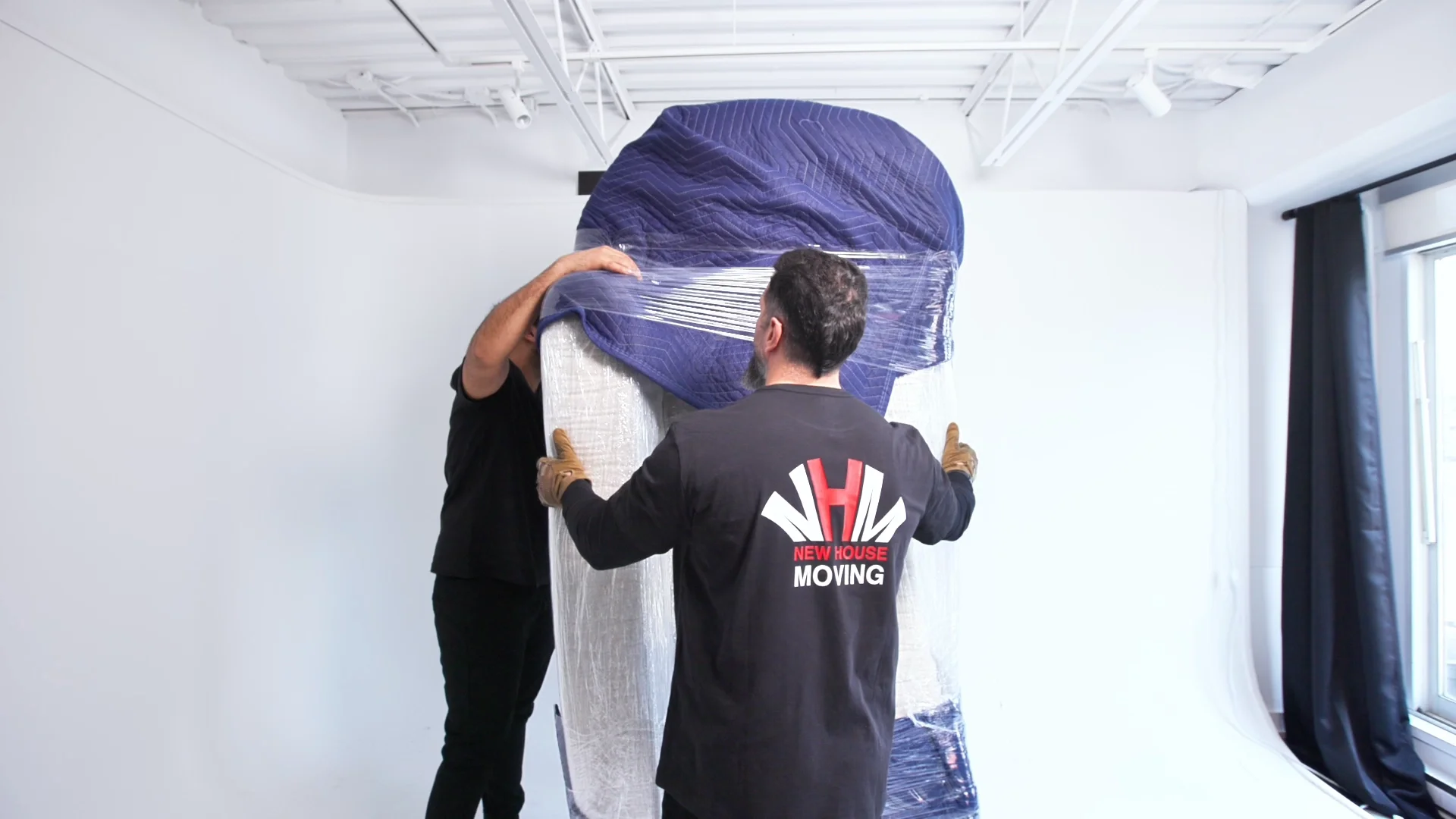 Packing and unpacking services with furniture wrapped in protective moving blankets for safe relocation in Toronto and the GTA.