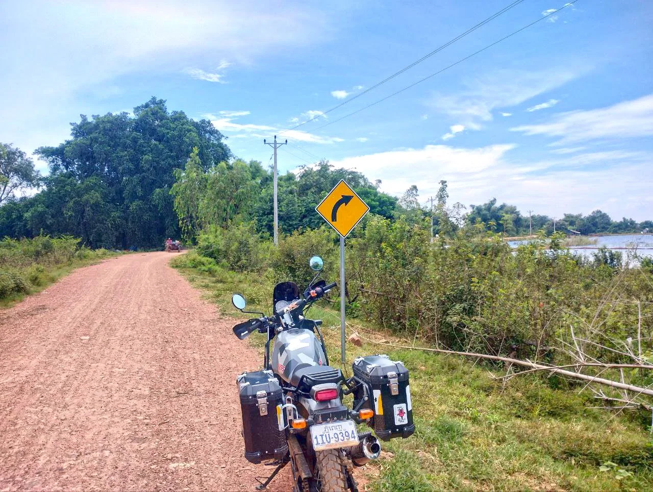 Motorbike on a dirt road by the Tonle Sap shore and nature