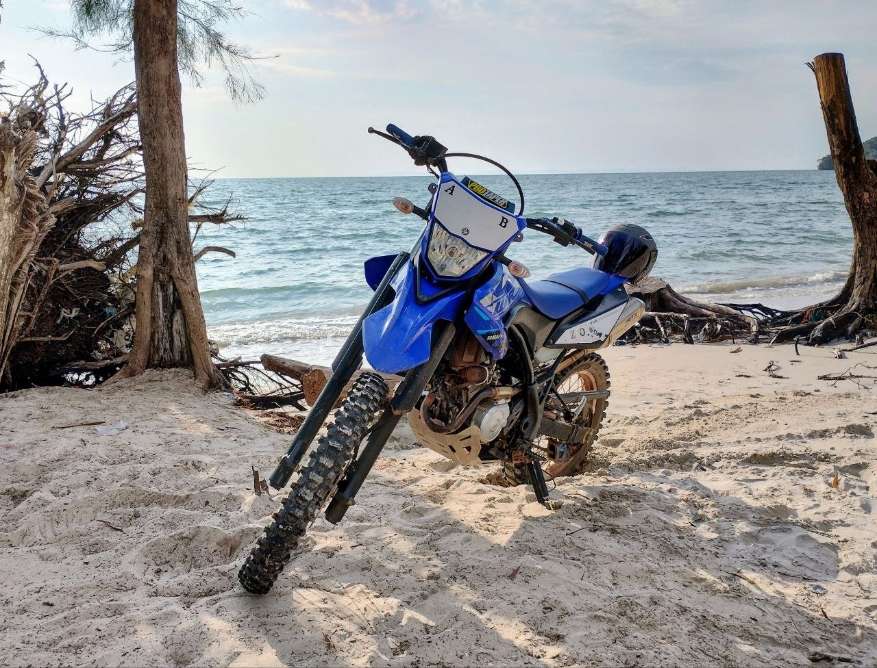 Blue Yamaha WR155 motorbike on the Cambodian Koh Kong white sand beach