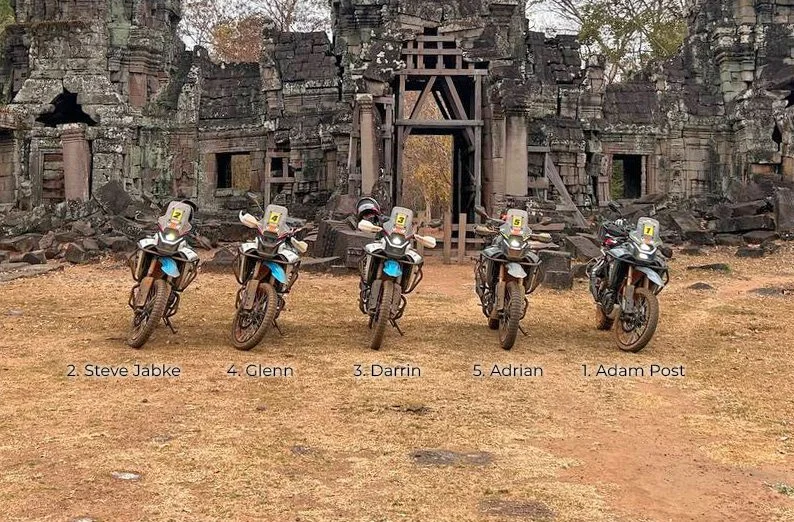Row of 5 CFMoto MT450 motorbikes in front of a Cambodian ancient temple
