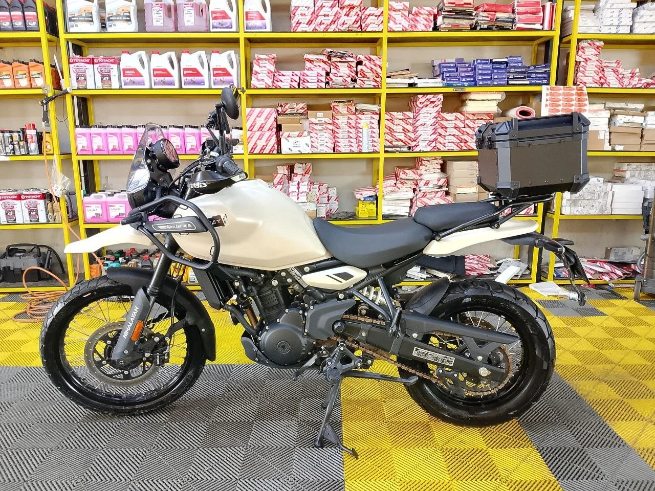 Cream Royal Enfield Himalayan 450 in a garage