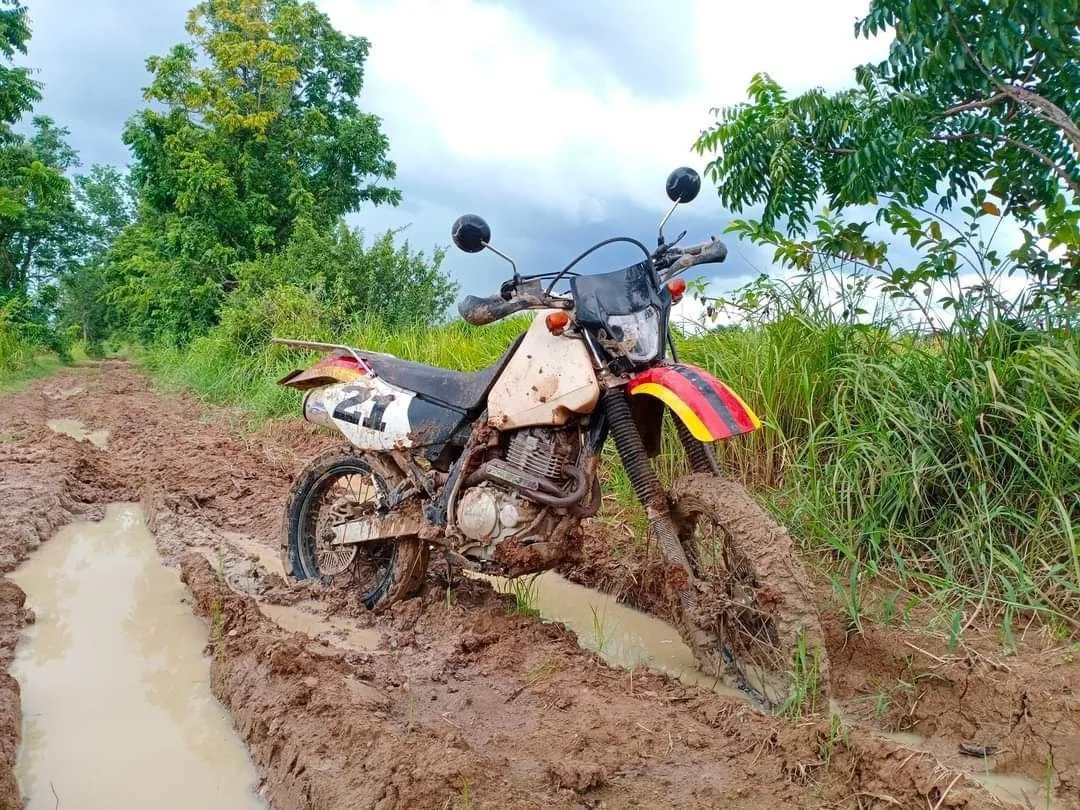 Honda XR400 motorbike in the muddy trail of Cambodia in the wild