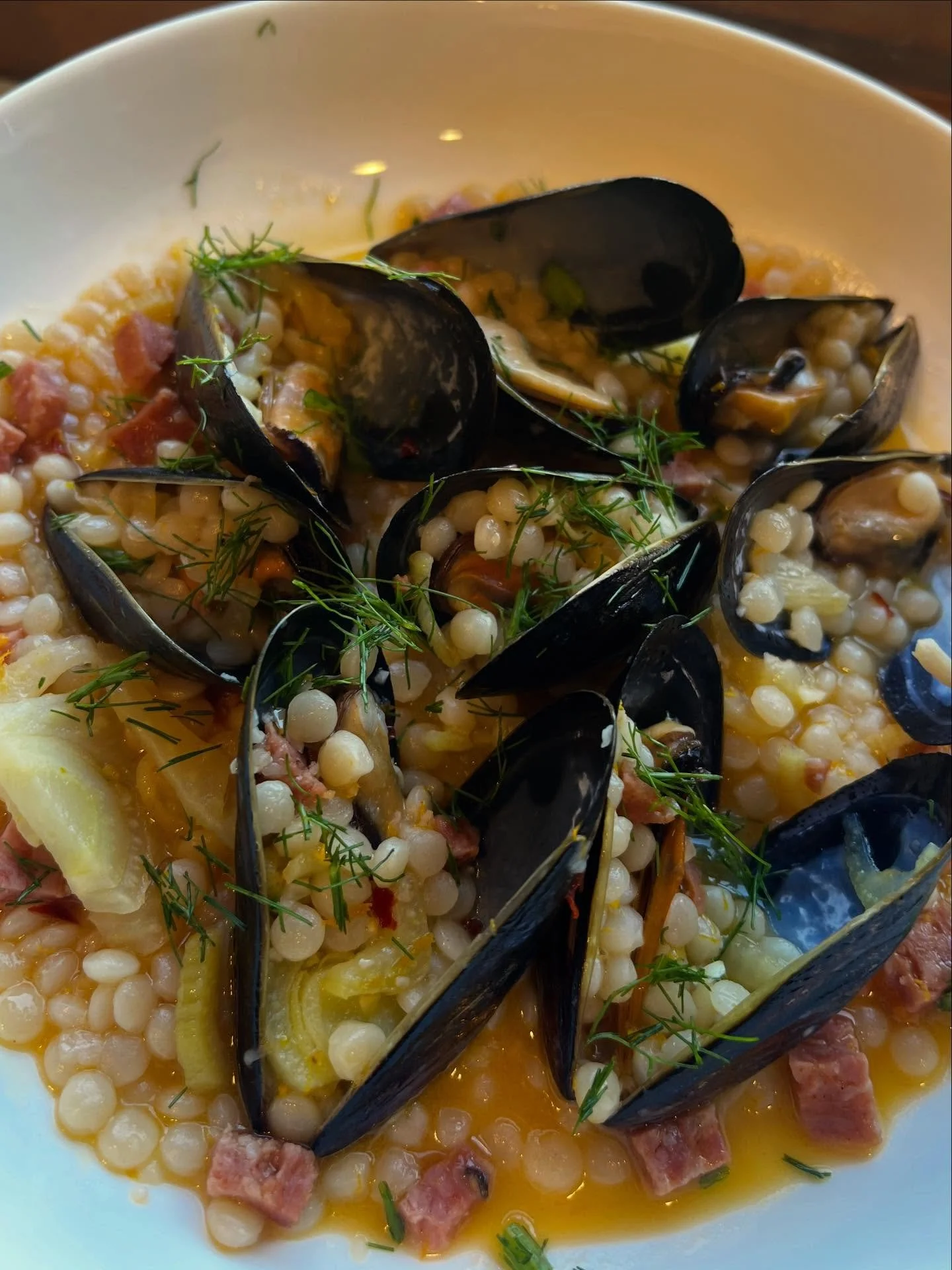 Steamed Mussels &bull; Fresh Fennel &bull; Citrus-Infused White Wine Sauce &bull; Couscous &bull; Finocchiona salami 

My favorite part of this dish is using the shell to scoop up all the goodies😋
