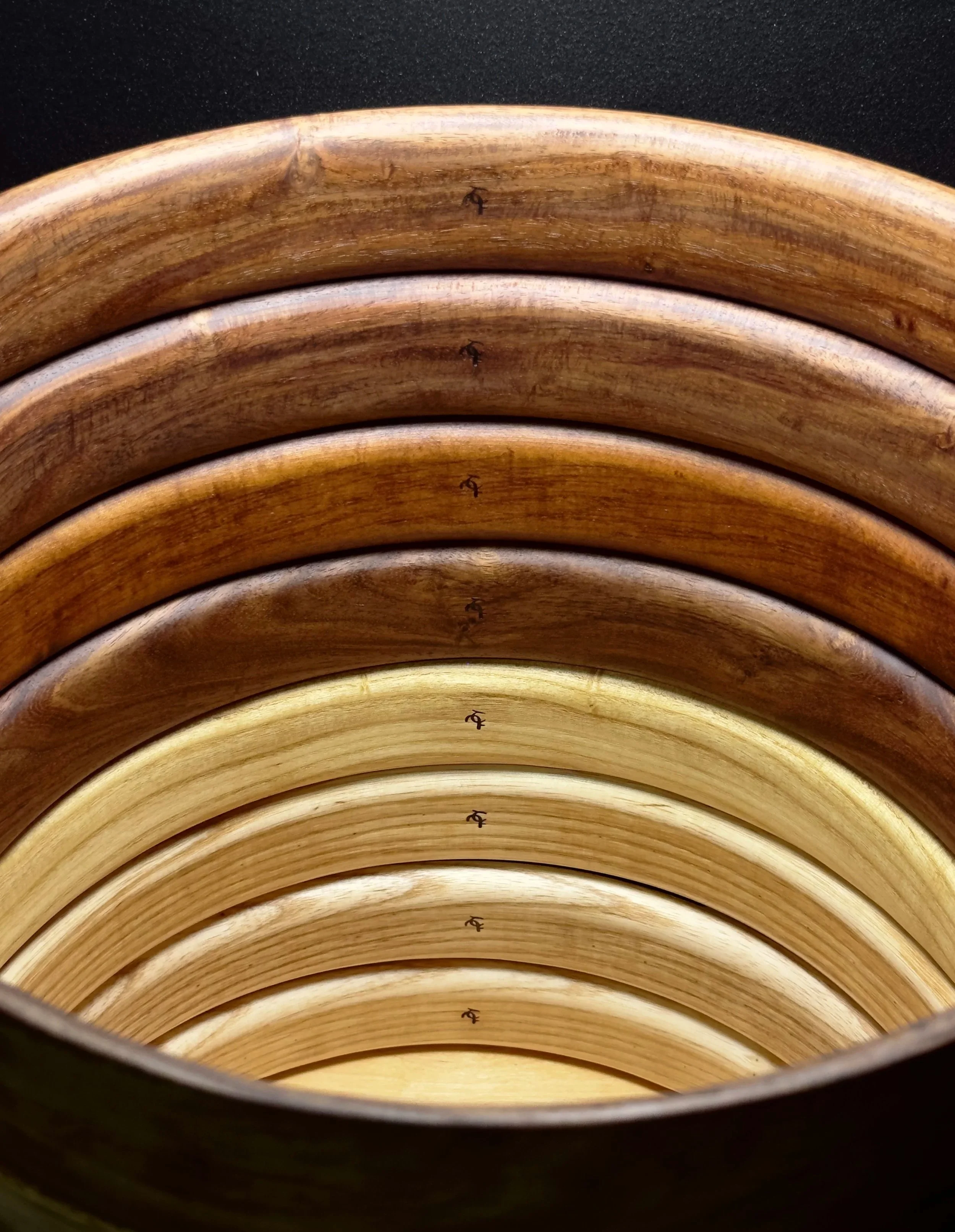The frame drum hoops, stacked one on top of the other before the rings are installed. This showcases the look and finish of the wood itself.