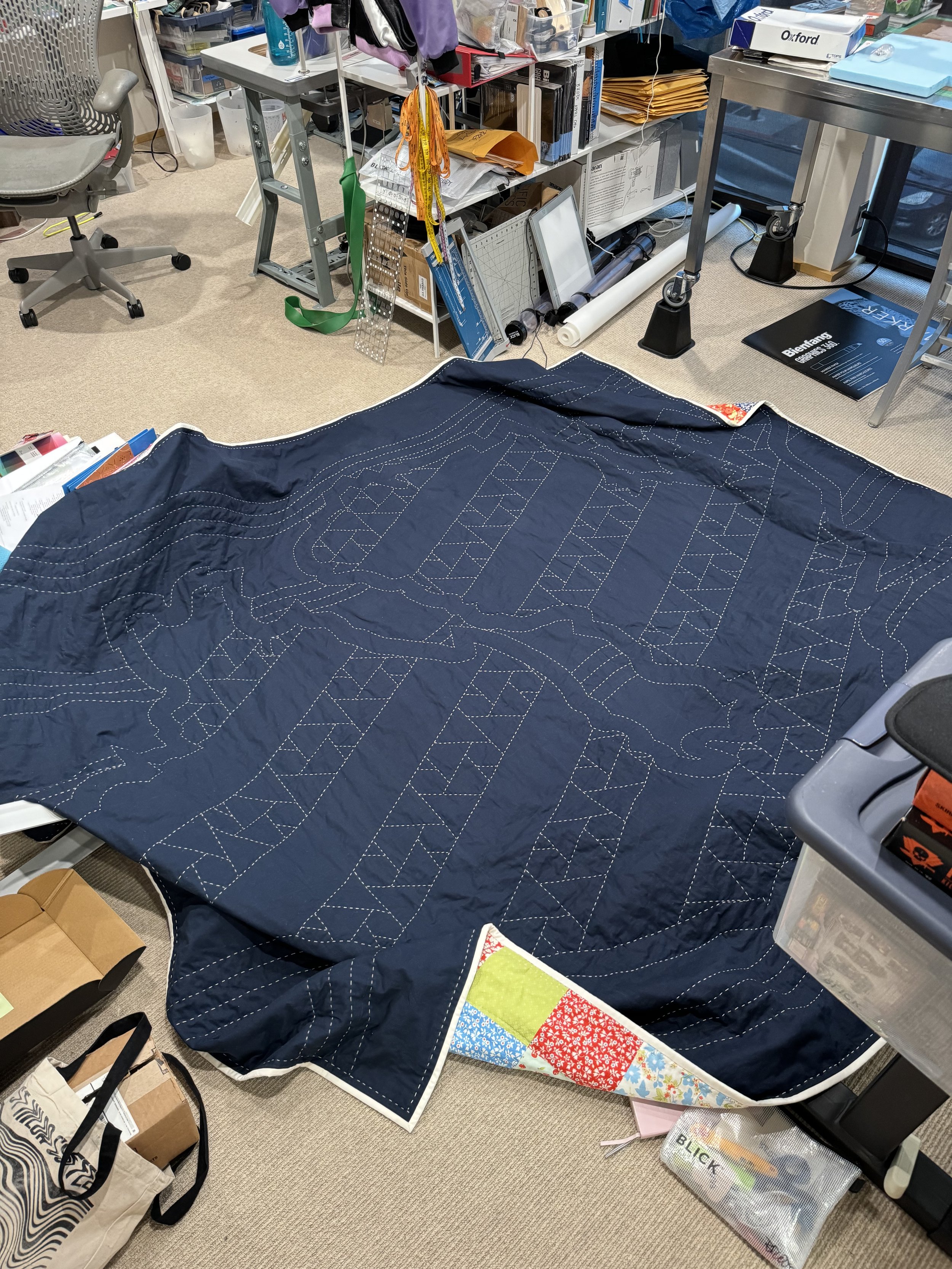 Hand-stitching the quilt - this messy shot shows the quilt exceeding the size of my workspace!