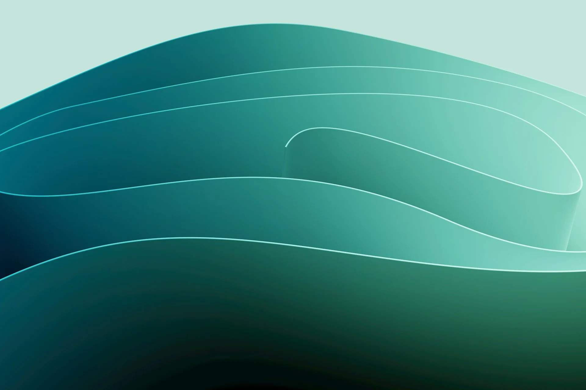 Dirt path winding through dry grass field with sparse shrubs under a clear sky.