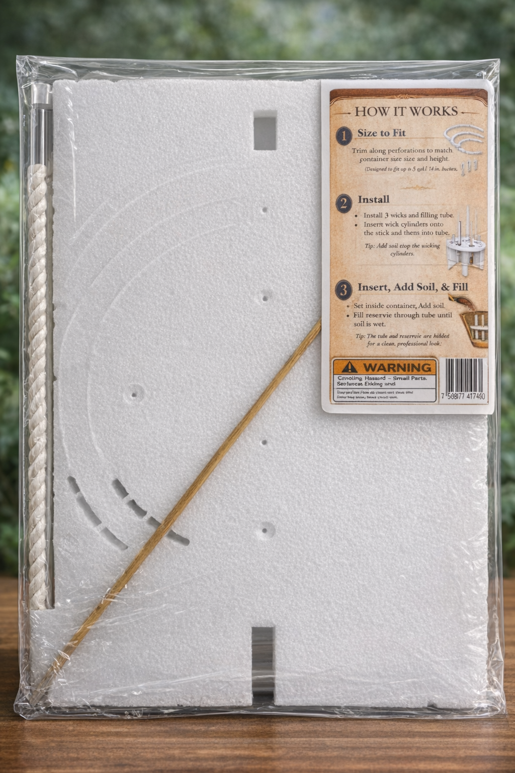 A package containing a small underground planting kit with instructions and tools on a wooden surface, with a green garden background.