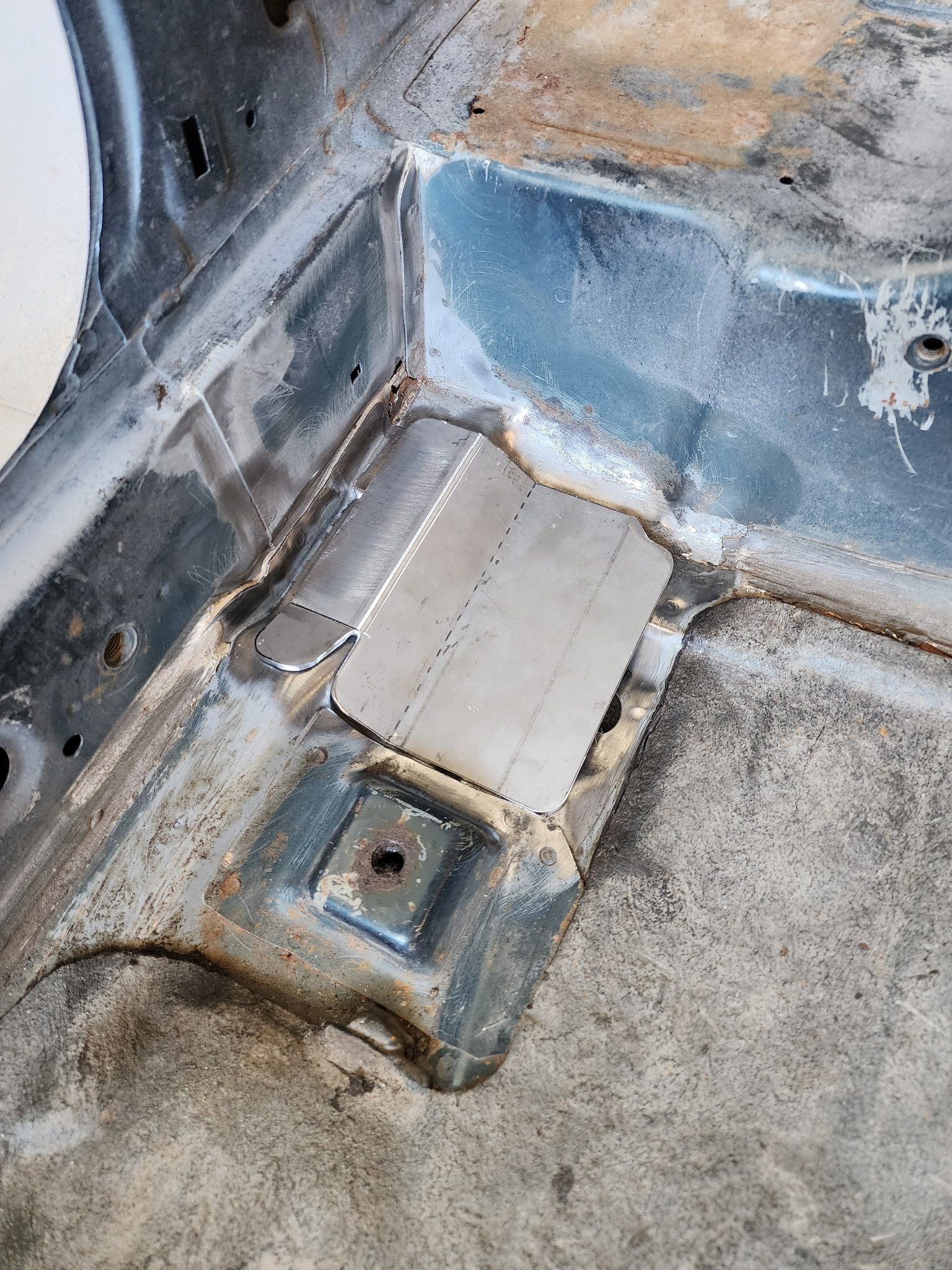 Custom roll bar mounting plate fabrication in a Nissan 240SX S14 chassis during structural reinforcement and performance build development.