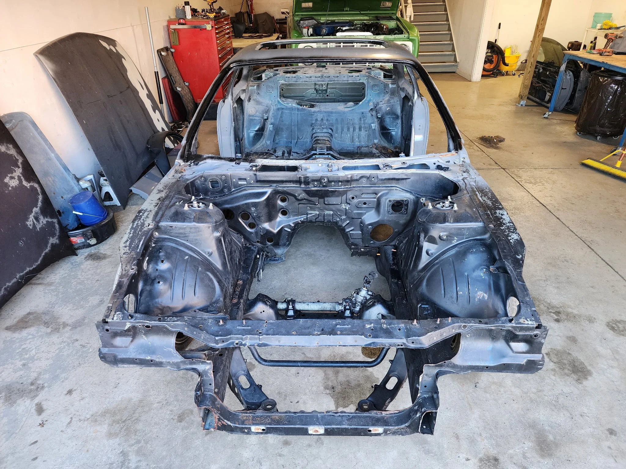 Nissan S14 240SX engine bay stripped and prepped for custom drivetrain swap and fabrication work