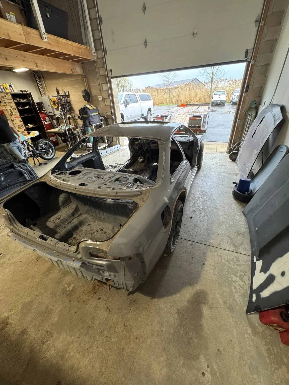 Nissan S14 240SX full chassis teardown showing stripped interior and rear structure during performance build