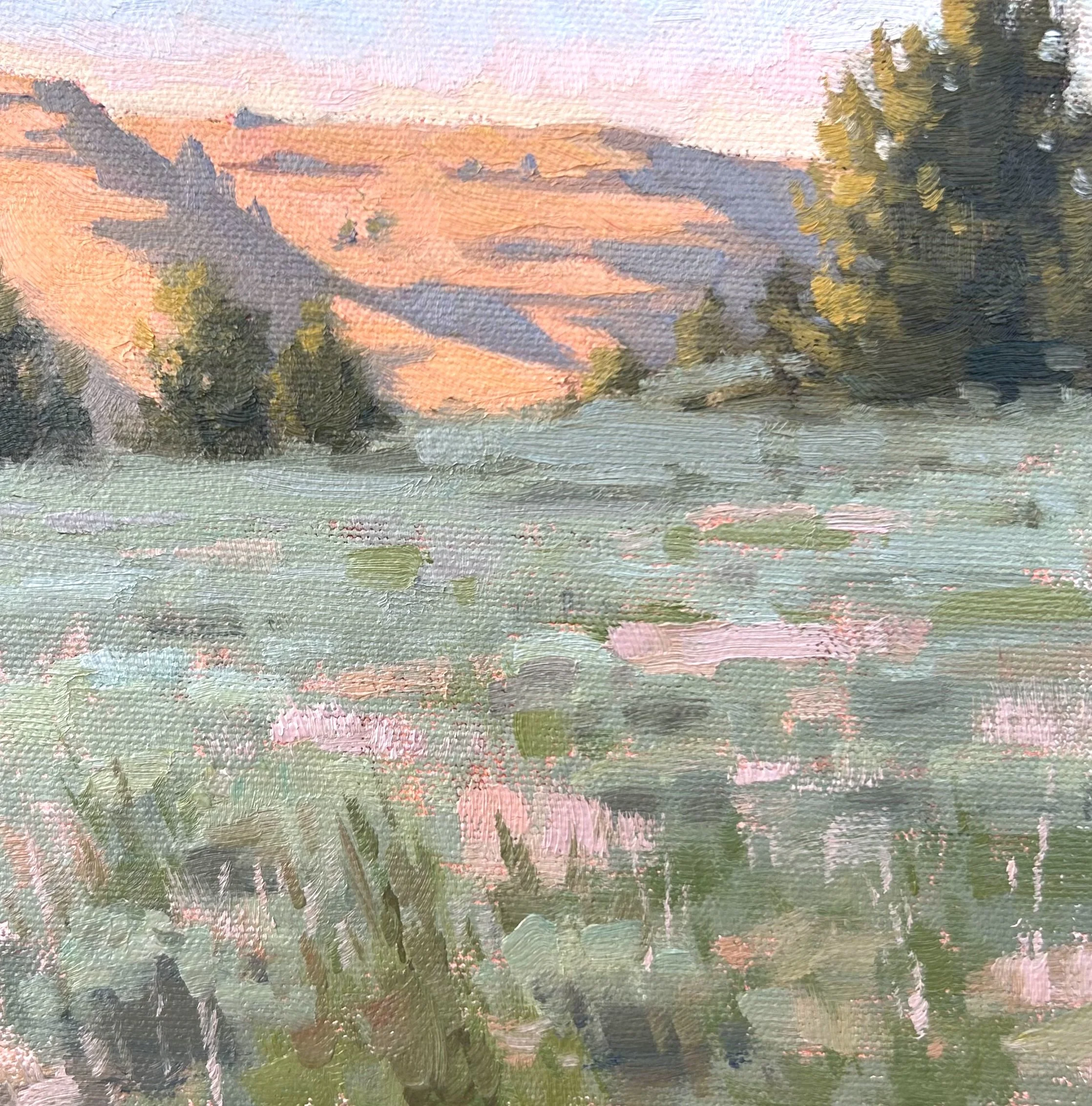 Close-up of an impressionistic landscape painting featuring trees in the foreground, a hill or mountain in the background, and a colorful sky at sunset.