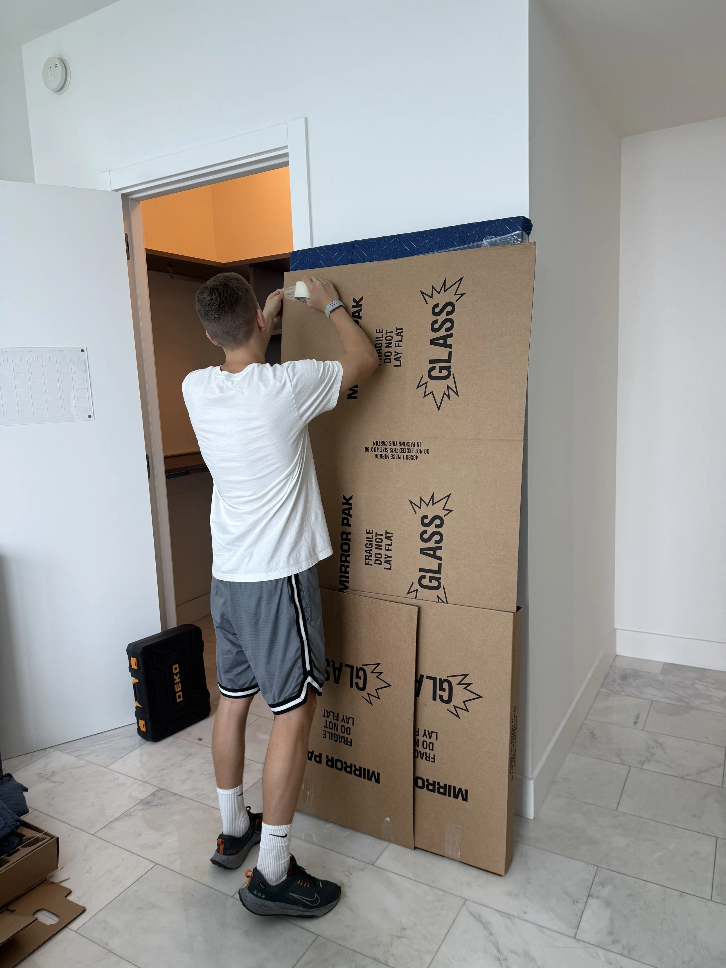 biscayne moving co. worker wrapping glass in miami local move