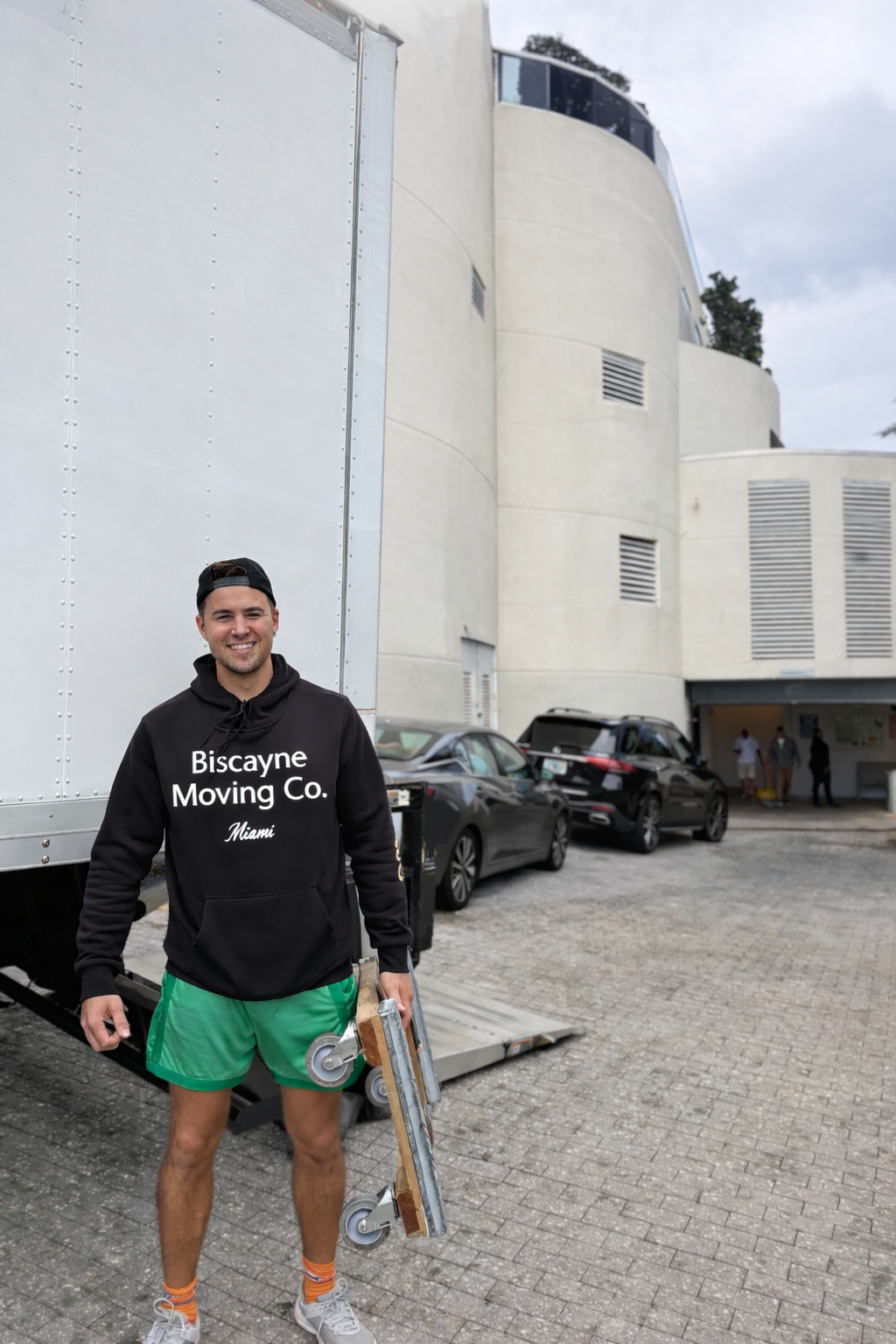 Professional mover standing in front of a moving truck during a local residential move, Biscayne Moving Co providing local moving services
