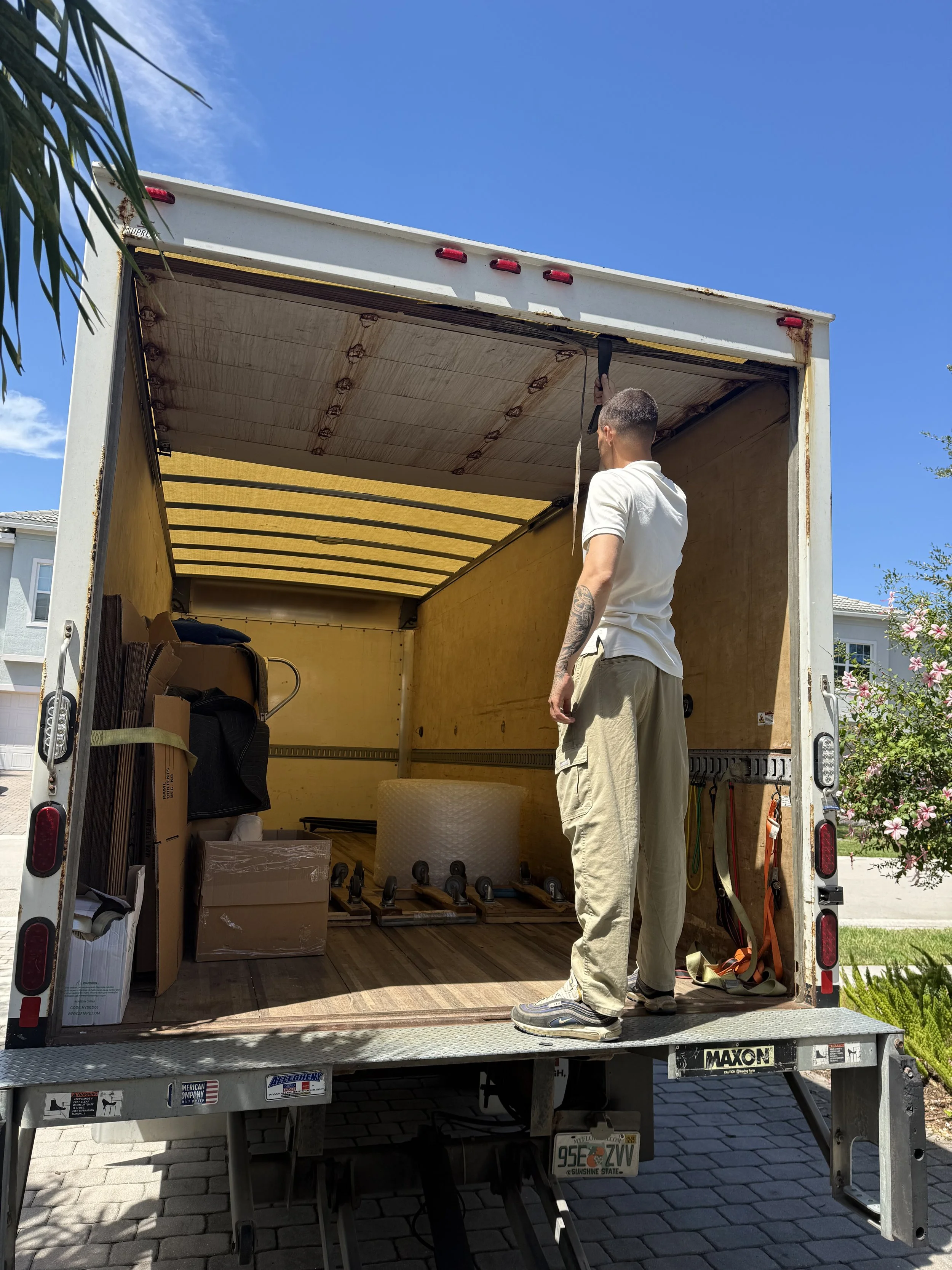 Biscayne Moving Co. Worker closing the truck after finishing a home move in hollywoof, fl.