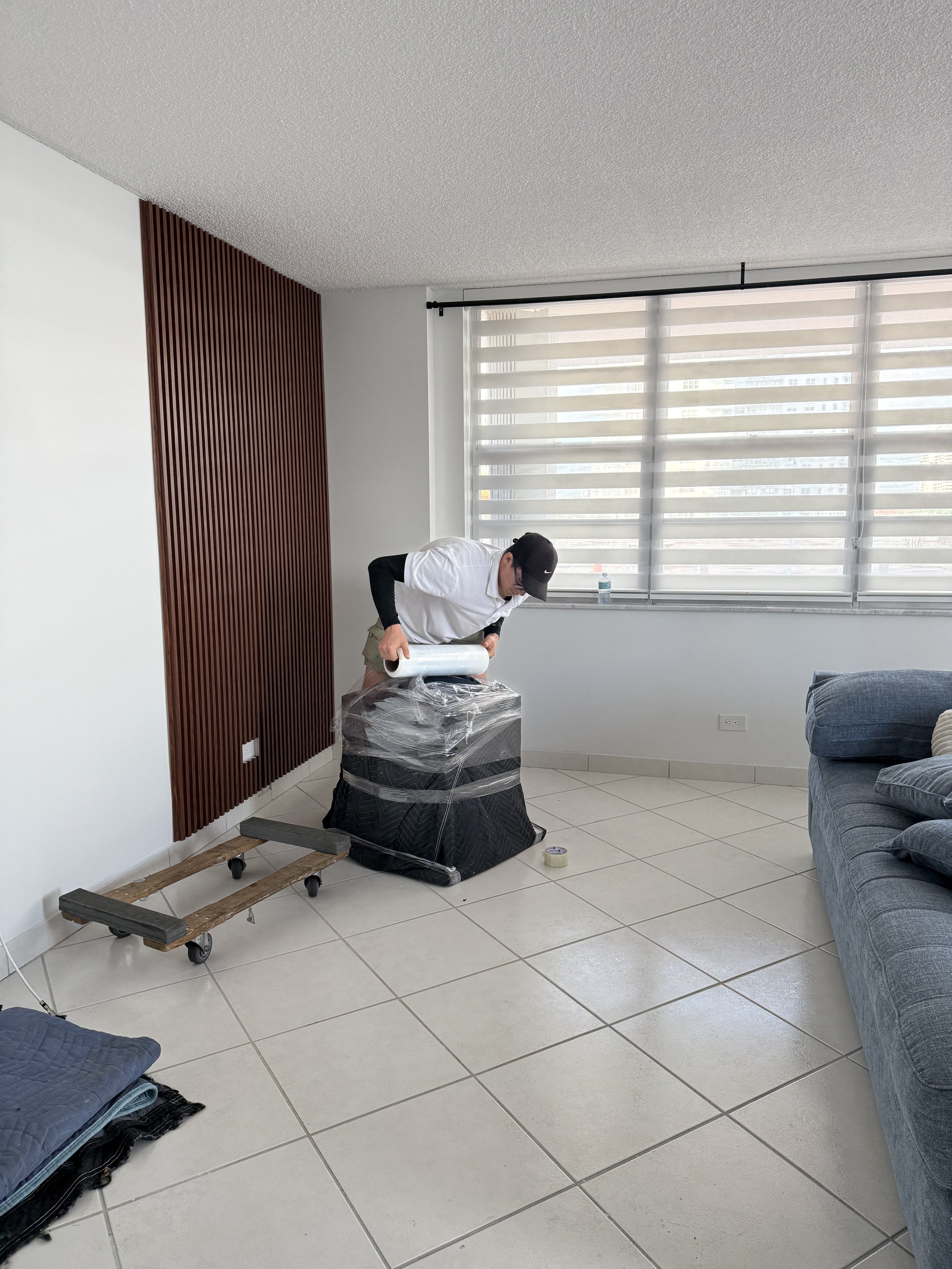biscayne moving co. mover wrapping furniture in sunny isles local move