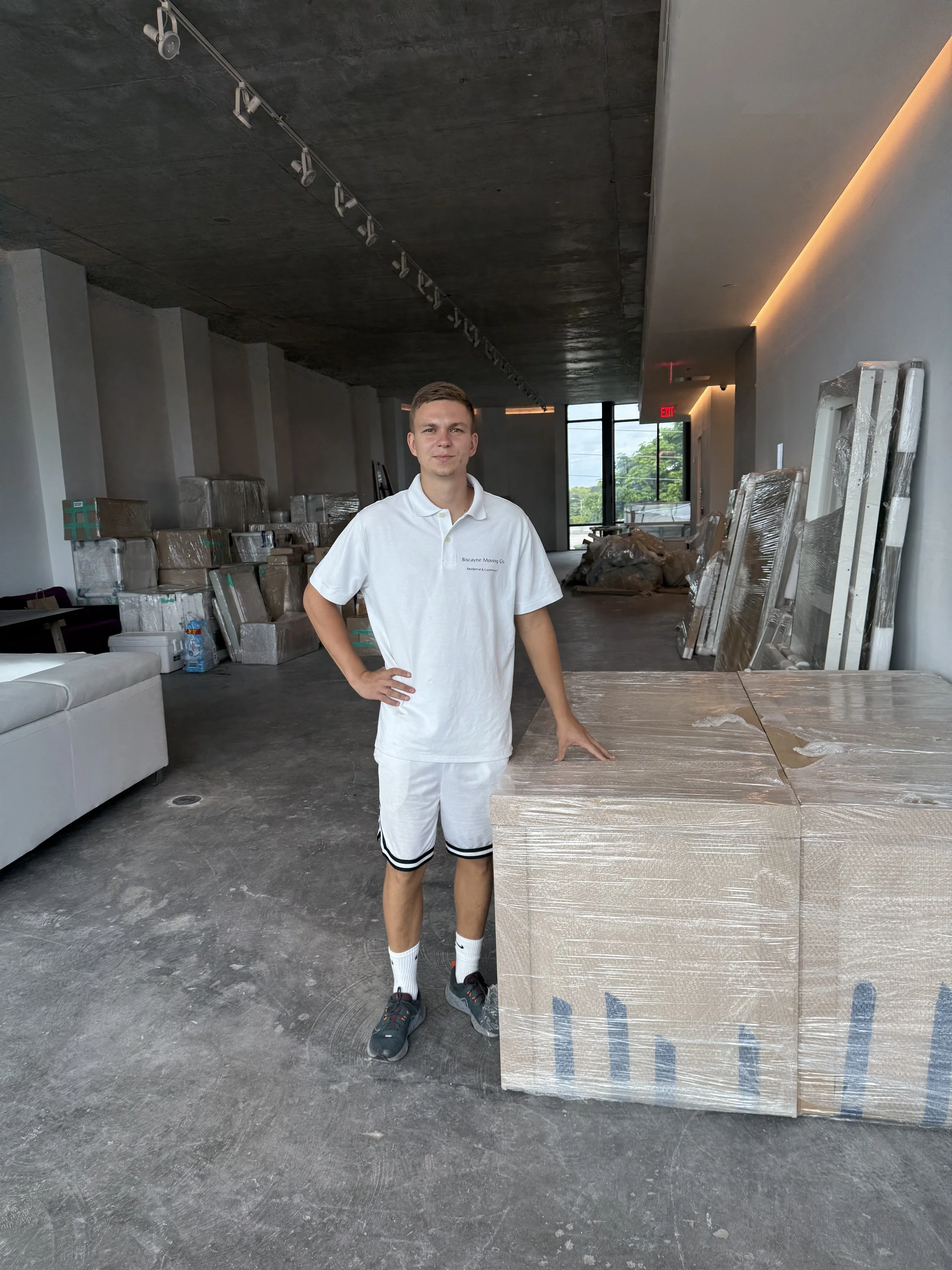 Experienced commercial mover overseeing showroom setup during Wynwood Miami commercial move